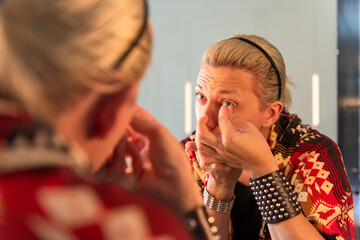 Person applying contact lenses carefully.