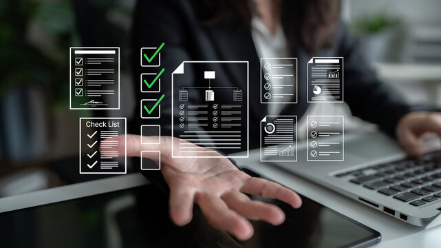 Business Professional Using Digital Tools for Project Management and Task Organization with Documents and Checklists in Modern Office Setting. Bitwise.