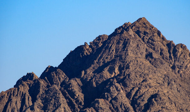 Rugged mountain peak under clear blue sky during daylight