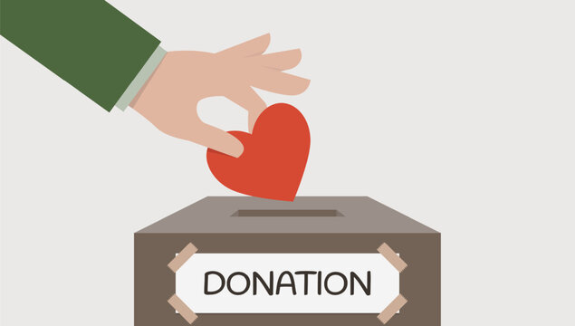 Person's hand put red heart symbol into the donation box. Concept of donorship, life saving or charity, sincere devotion to faith.