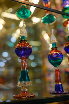 Colorful traditional blown glass perfume bottles standing on a shelf
