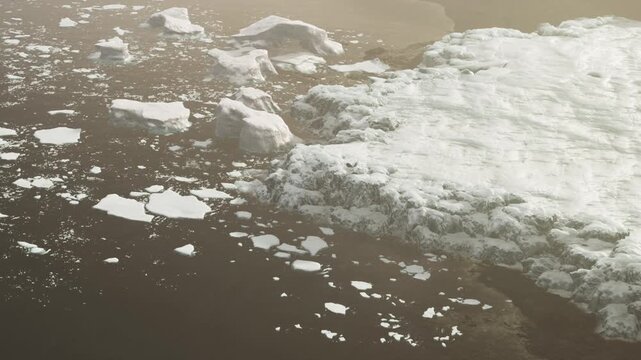 The view shows a mix of snow and ice resting on the waters surface. The shore appears dark, with patches of ice scattered across the water. This scene captures a chilly moment in nature.