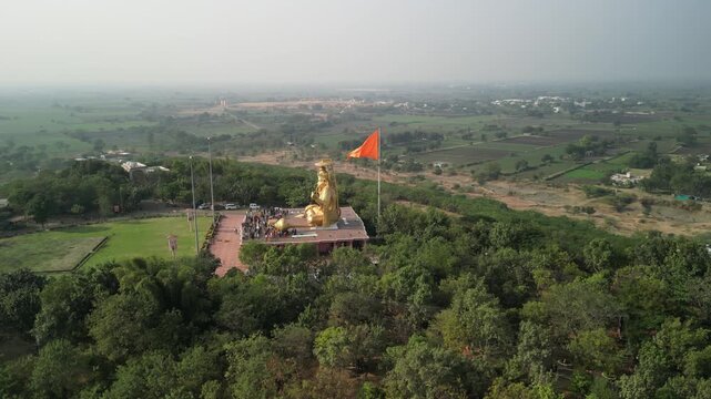 Aerial view orbiting right to back of giant Hanuman deity