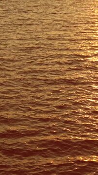 Rose Gold Sunset Reflection on Gentle Sea Waves