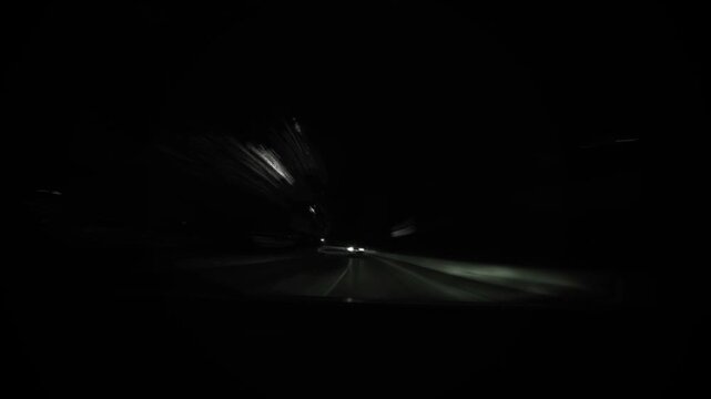 Cinematic night-time timelapse of a fast drive through a modern city, with glowing neon lights,