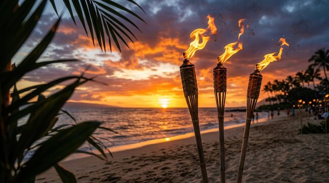 Tiki torches with open flames burning against a Maui sunset sky and clouds.