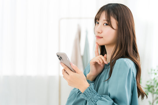 Young Asian businesswomen using smartphones in the office/workplace