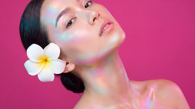 Iridescent woman portrait with a pink floral background