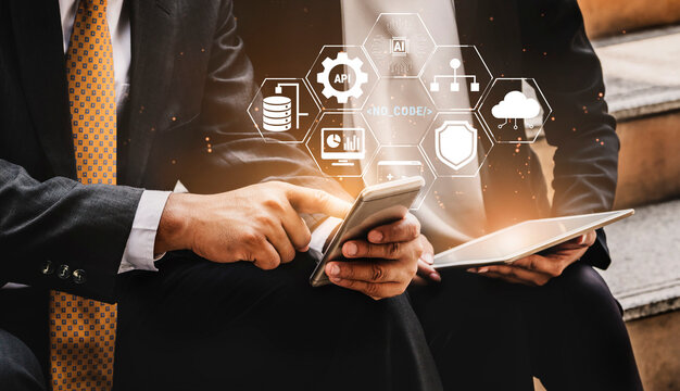 Business Professionals Engaging with Technology Solutions on Mobile Devices in Urban Environment with Digital Icons Representing Innovation Quark.