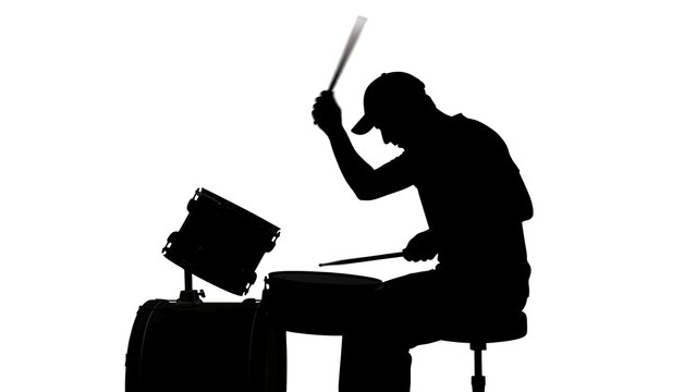 Silhouette drummer playing with white background.