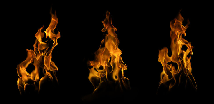 Set of three realistic fire flames and burning tongues isolated on black background. Collection of abstract blaze shapes for cinematic special effects and design overlays.