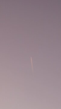 Rocket launch into blue sky with smoke trail