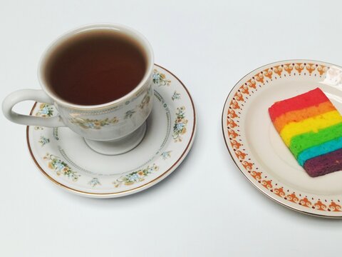 Black Coffee Cup with Rainbow Layer Cake Slice