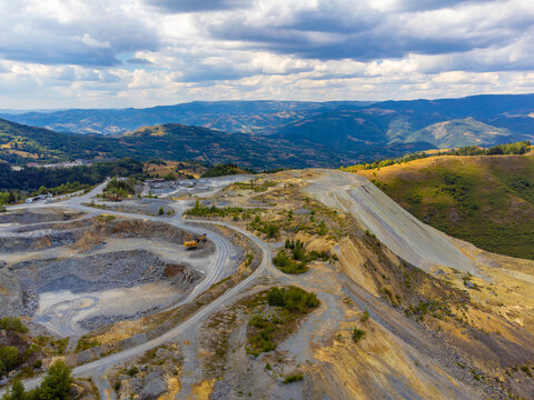 Aerial view of a tailings dump spilled into the mountains, resulting from the Rosia Poieni copper quarry in the Apuseni Mountains - Romania
