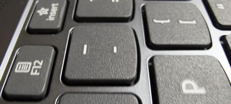 Close up macro view of black computer keyboard number pad keys with visible text and texture details for technology and office hardware concepts