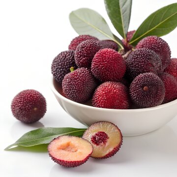 Fresh ripe Chinese bayberries in white bowl with whole and sliced fruit on white background