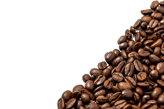 Roasted coffee beans clustered in the bottom right corner against a white background with copy space for text.
