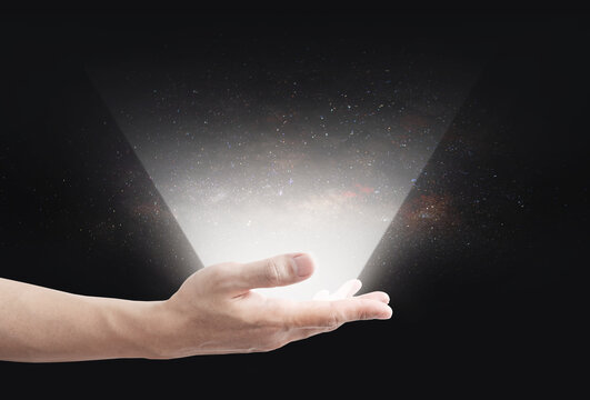 Bright light showing on human hand, with stars on backgrounds. Virtual reality, augmented reality, and empty space for product and etc. image