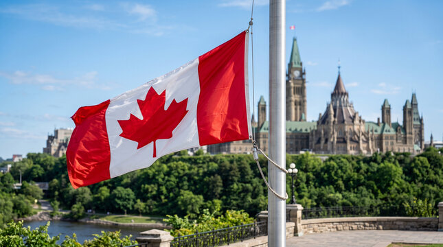 Canadian flag flying at halfmast in front of the parliament buildings in ottawa, ontario, canada, on a sunny summer day with blue sky and lush green trees