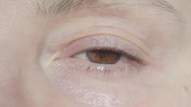 Eye Closing Moment Macro. Woman brown eye closing slow motion macro close up. Macro slow motion video woman brown eye closing. Eye closing macro shot woman brown eye slow motion. 