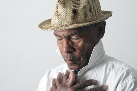A serene portrait of a man praying with hands together in deep prayer that perfectly captures themes of faith, hope, mindfulness, and inner peace stock image stock photo