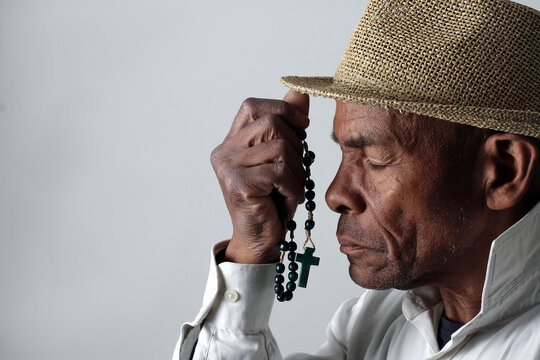 A serene portrait of a man praying with hands together in deep prayer that perfectly captures themes of faith, hope, mindfulness, and inner peace stock image stock photo