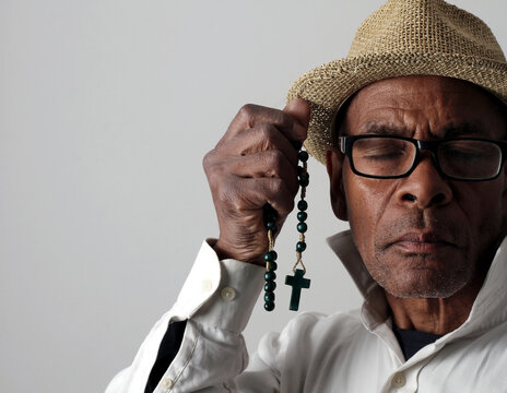 A serene portrait of a man praying with hands together in deep prayer that perfectly captures themes of faith, hope, mindfulness, and inner peace stock image stock photo