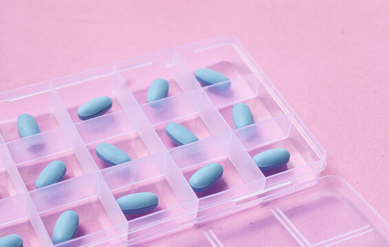 Blue PrEP pills organized inside a plastic pill box