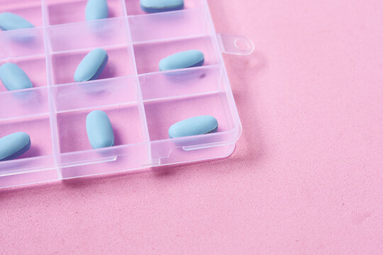 Blue PrEP pills organized inside a plastic pill box