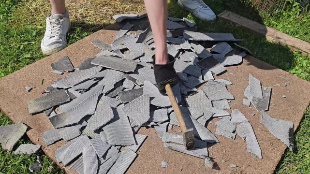 Breaking tiles on a sunny day in a backyard