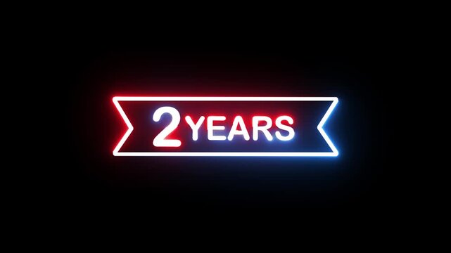 Neon glowing 2 years text inside frame with changing red and blue lights isolated black bg.