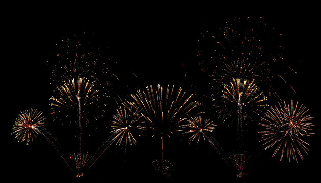 Spectacular Golden Fireworks Display Illuminating the Dark Night Sky with Bursting Explosions and Trails of Light