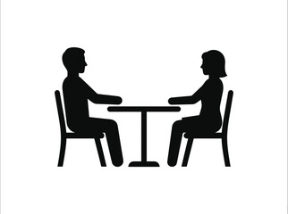 Fototapeta premium Silhouette of a man and woman sitting at a table