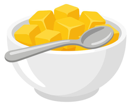 Bowl of fresh diced mango cubes with a silver spoon isolated on white background