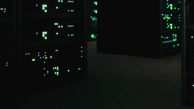 Servers are arranged in rows inside a dark room. Blinking lights on the servers indicate activity. The setting is typical for data storage and processing tasks done at night.