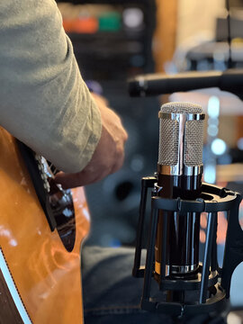 Playing acoustic guitar in recording studio.1