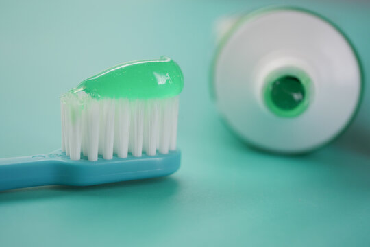 Green toothpaste on a blue toothbrush