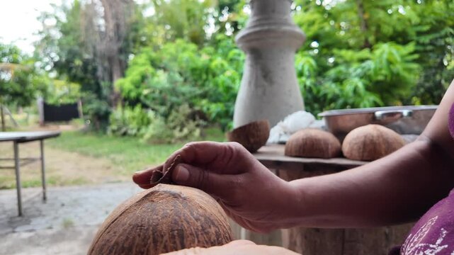 Handmade craft process showing an artisan shaping and polishing a natural coconut shell into a traditional reusable cup using sustainable materials.