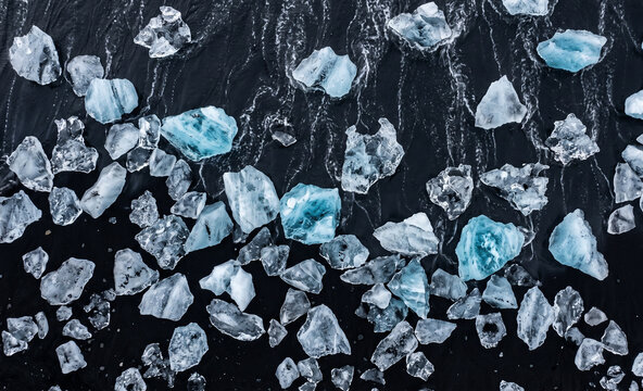 Aerial Pattern of Glacial Ice on Black Volcanic Sand at Diamond Beach