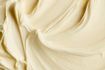 Fototapeta premium Buttercream frosting on a smooth surface ready for cake decoration in a home kitchen setting