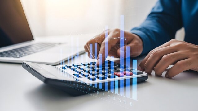 Person calculating financial data on calculator