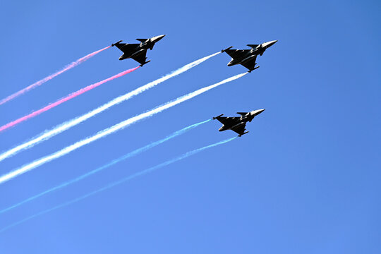 Budapest, Hungary - 08.20.2026: Airshow by the Parliament above the Danube river. Military fighting planes releasing colorful smoke streaks. red, white and green. celebration of the country foundation