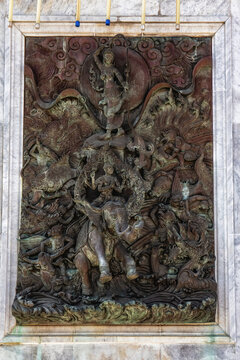 Intricate wall art details at Wat Traimit temple, Bangkok, Thailand