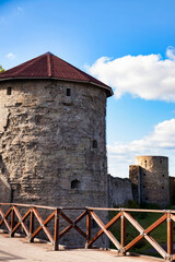 Ancient Stone Towers Stand Tall Within a Historic Fortress Under a Bright Blue Sky During the Day © Aleksandr