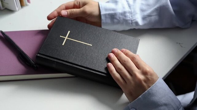 Female hands opening the Bible