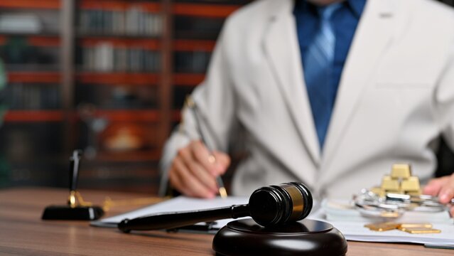 Lawyer upholds justice signing legal paperwork, pursuing justice in court trials when ensuring justice under legal authority.