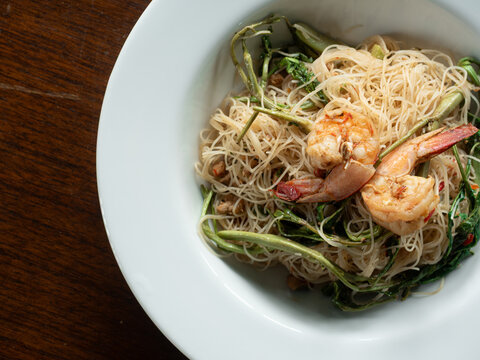 top view stir-fried rice vermicelli noodles with water mimosa and prawns