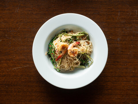 top view stir-fried rice vermicelli noodles with water mimosa and prawns