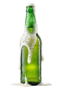 a chilled green glass beer bottle with foam on transparent background