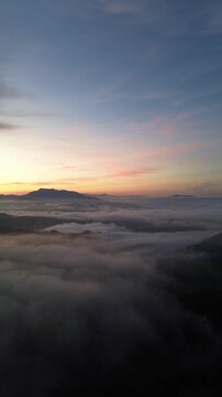 Aerial View of Sunrise Over Clouds and Mountains
